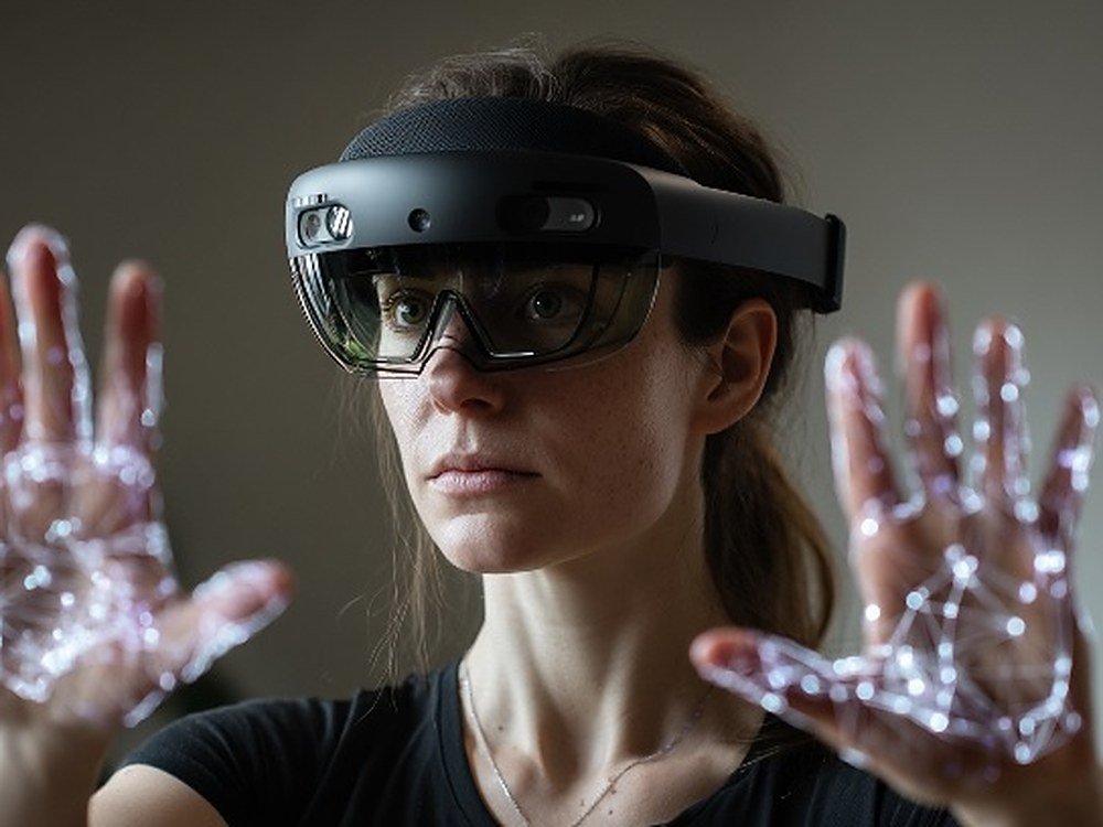 A woman wearing an XR headset with hand-tracking landmarks projected across both palms